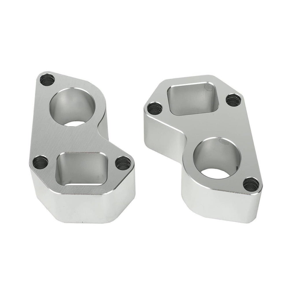 Pair of silver water pump spacer blocks with circular openings and threaded bolt holes