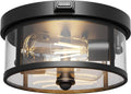 Black outdoor ceiling light with clear glass shade and motion sensor capsule