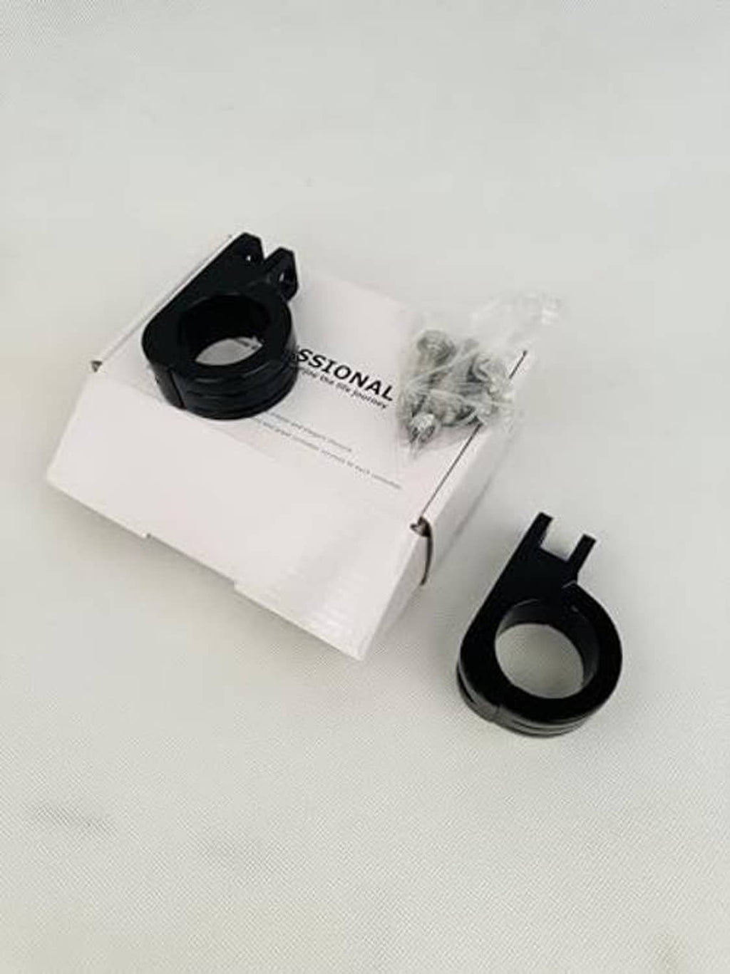 Black clamp brackets for foot pegs with hardware and instruction box