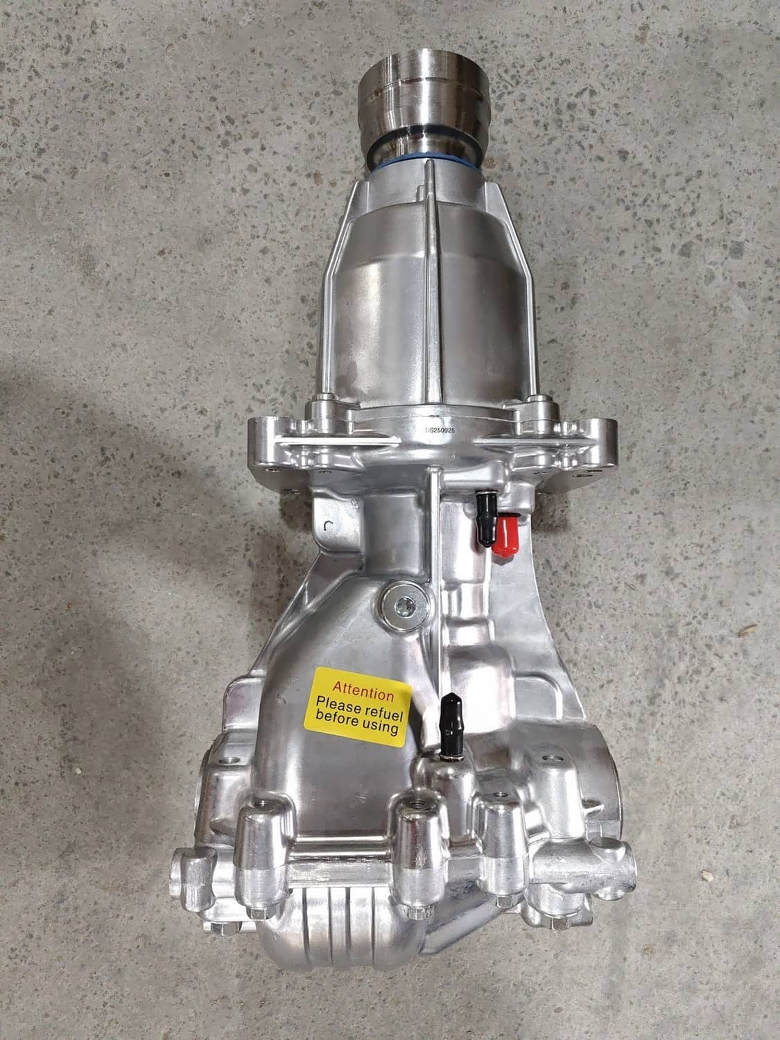 Rear differential assembly with silver housing and mounting flange, shown from above.