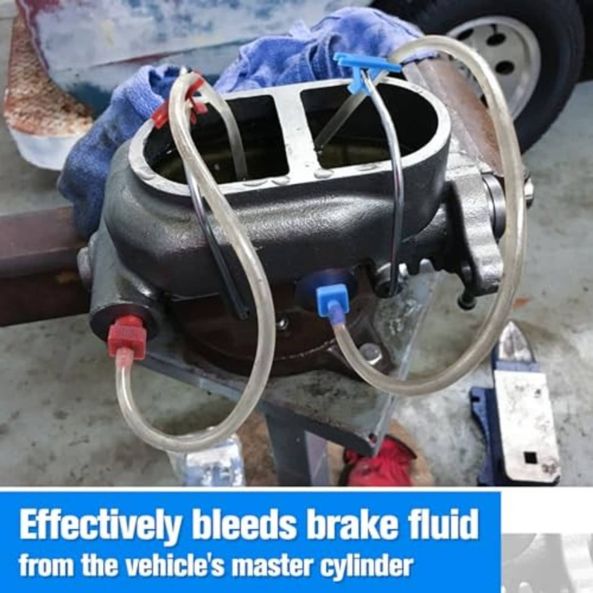 Clear bleeder hoses connected to a vehicle master cylinder assembly with red valve tips
