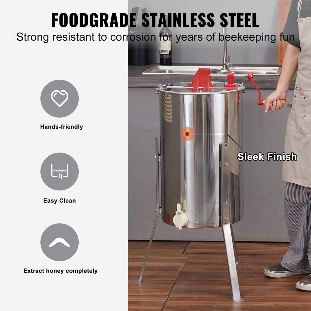 Stainless steel honey extractor drum with red handle and side spigots on tripod
