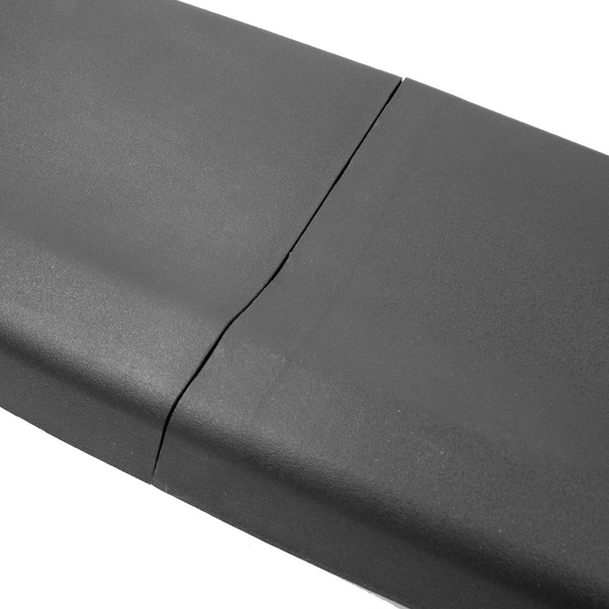 Close-up of dark gray/black tailgate cover molding spoiler seam and texture