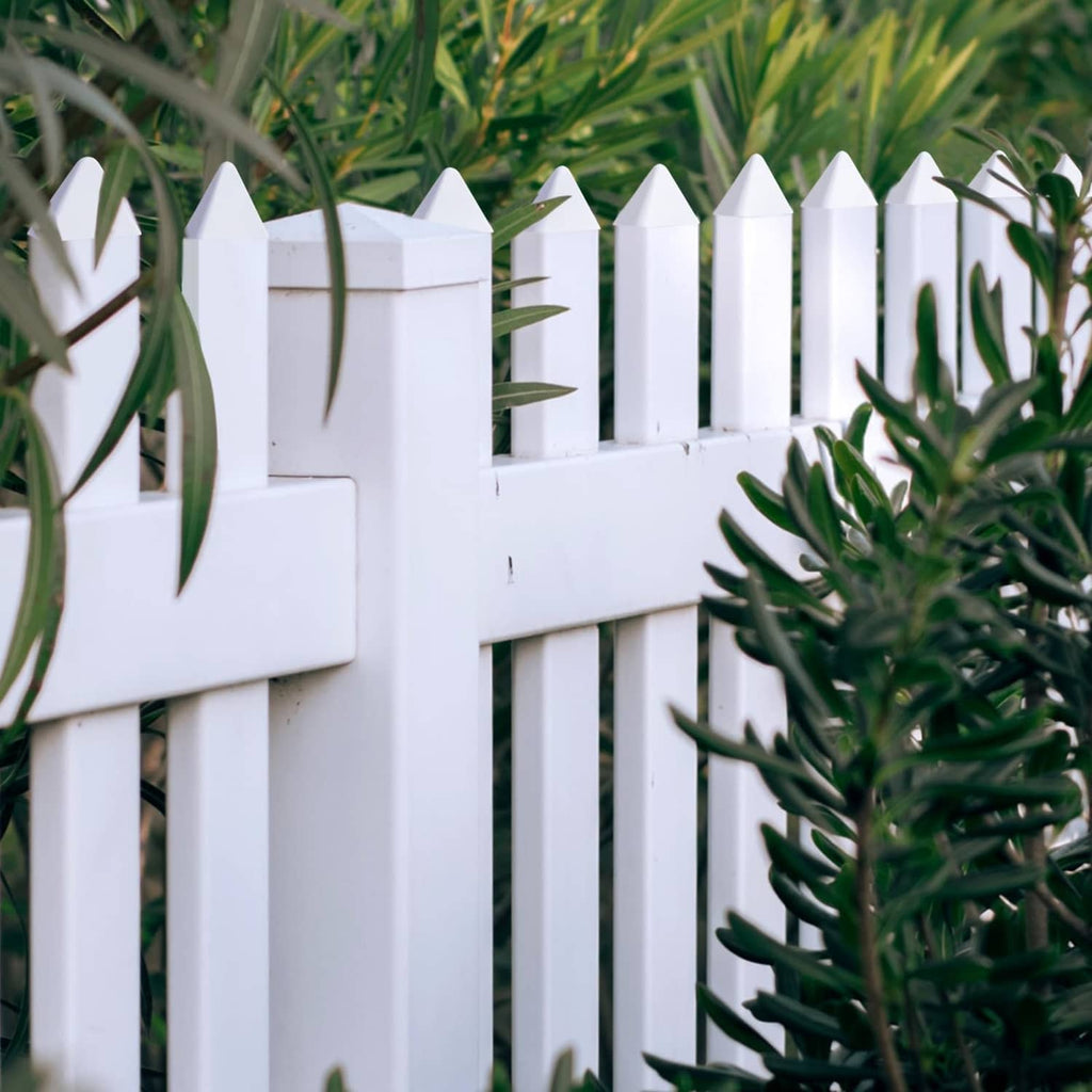 White vinyl picket fence caps on fence top rails and post ends