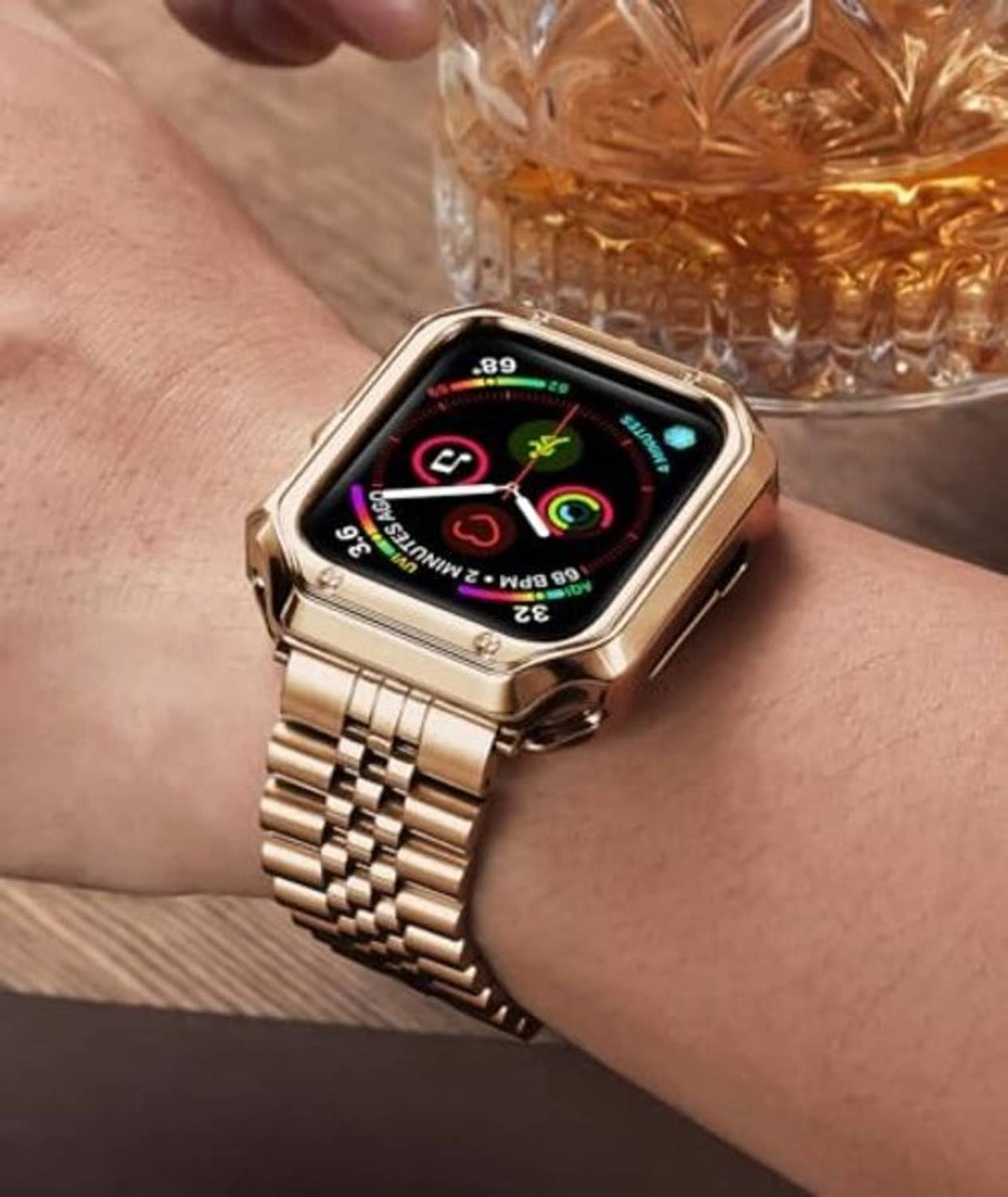 Rose gold metal link Apple Watch band on wrist, clasp visible