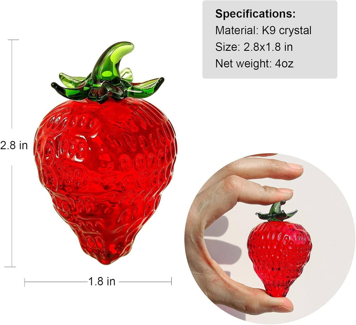 Red glass strawberry paperweight figurine with green leaves held in hand for scale