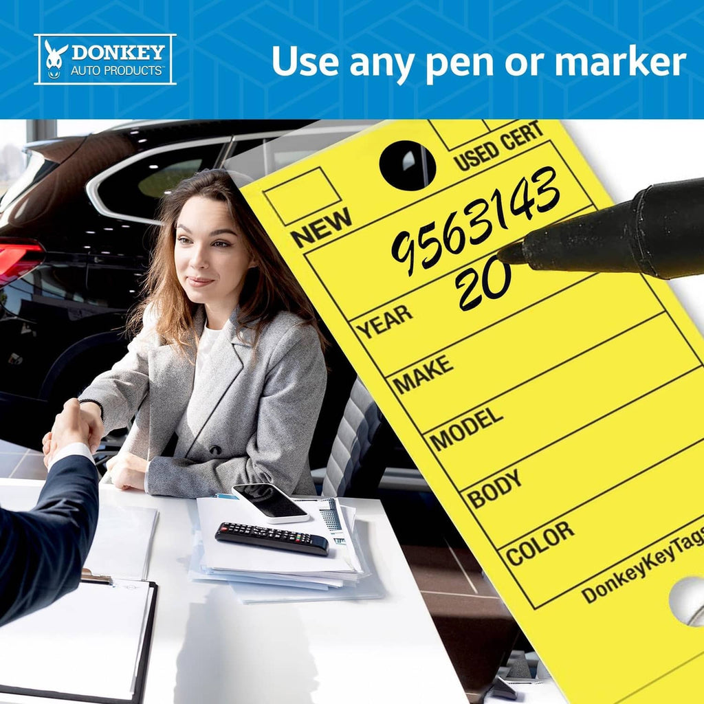 Yellow laminated key tag with year, make, model, body, and color fields attached to a key