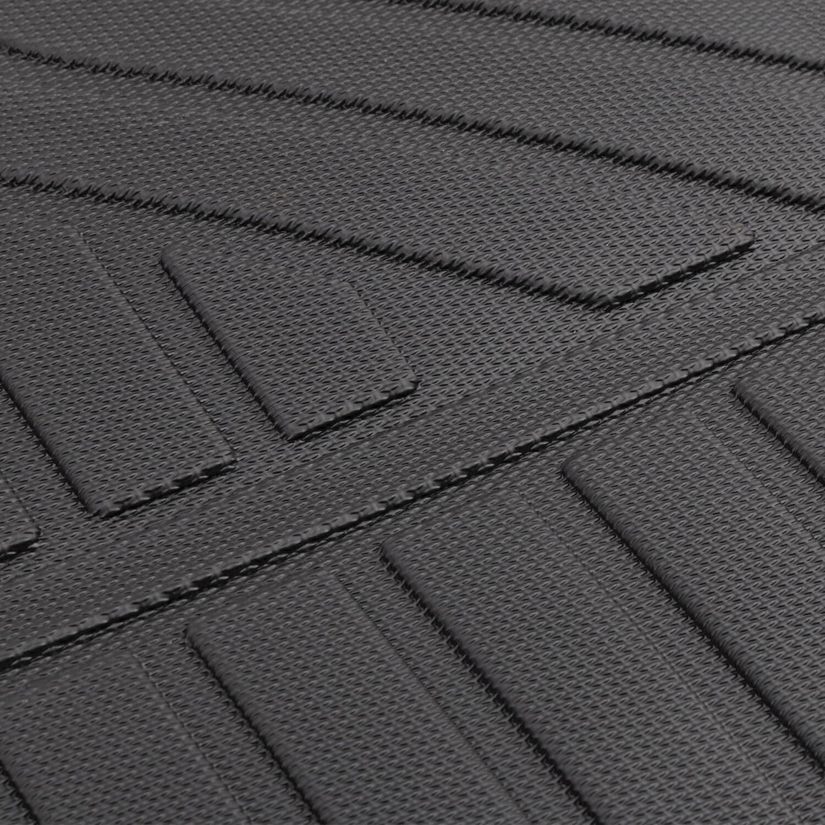 Black textured floor mat segment with raised lines and stitched edge