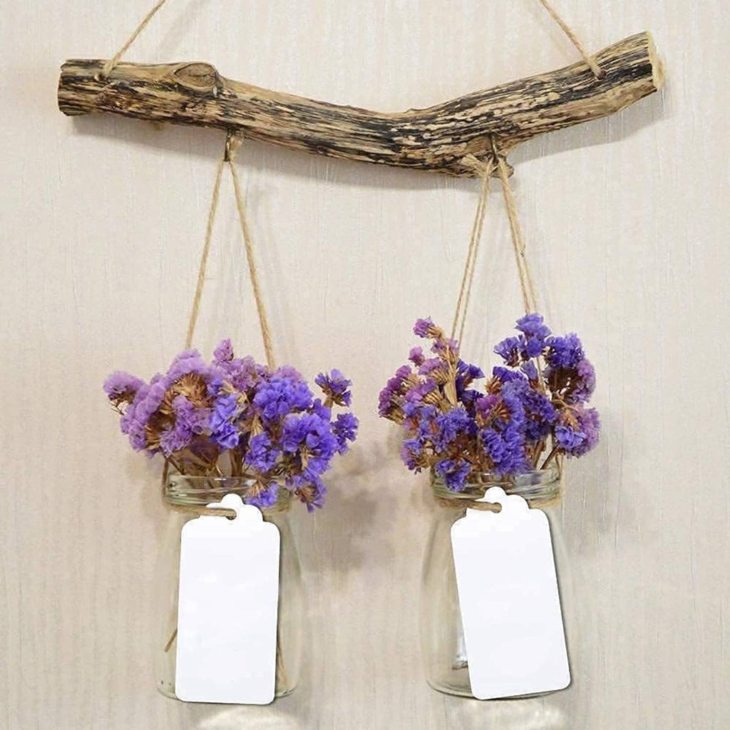 Two white blank paper gift tags hanging on twine loops