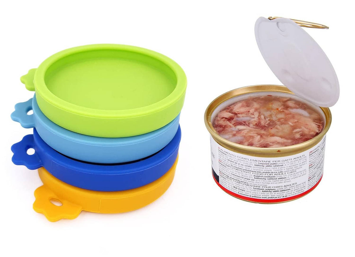 Three silicone pet food can lids in green, blue, and orange with a covered can