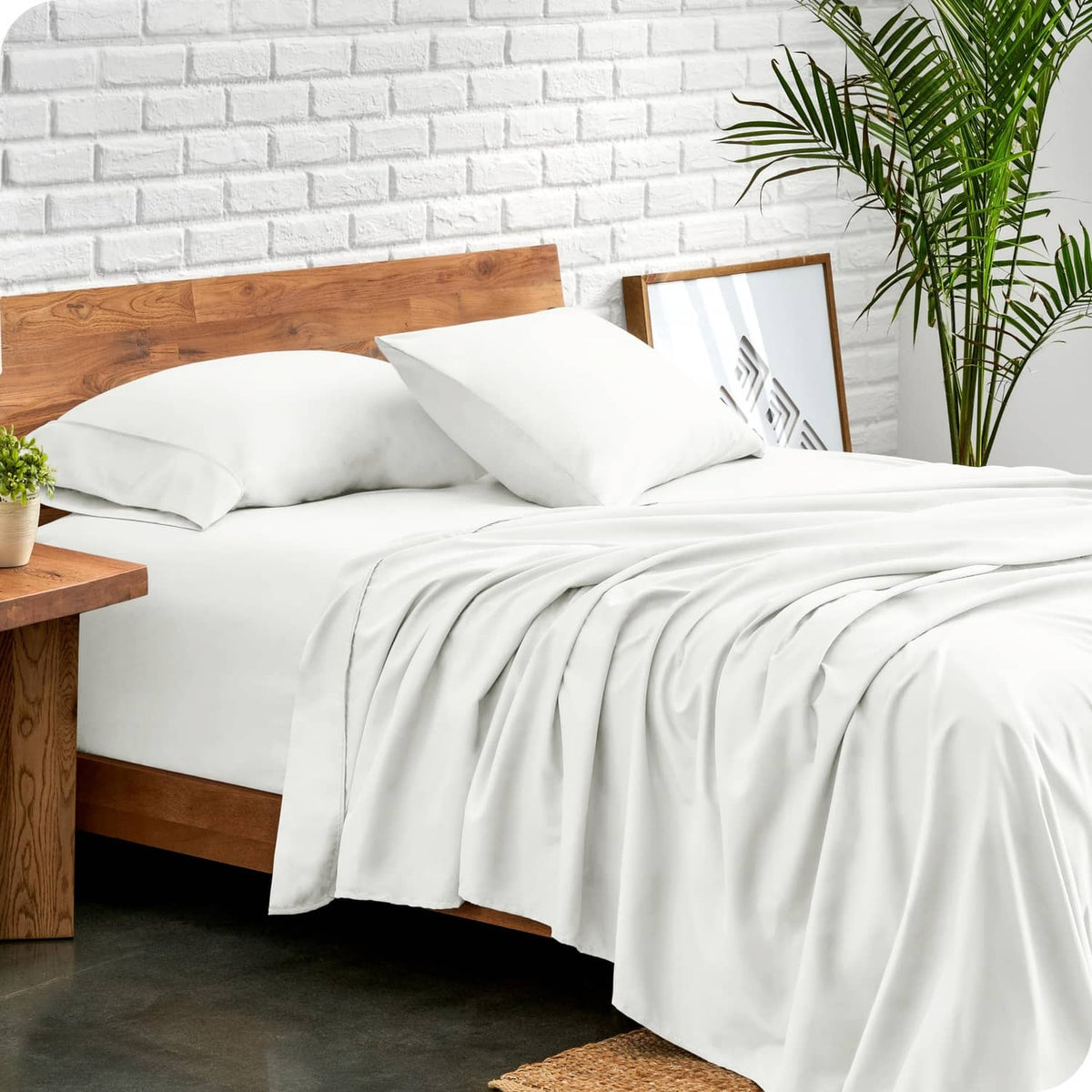 Cream bed sheet set with fitted and flat sheets, neatly styled on a bed
