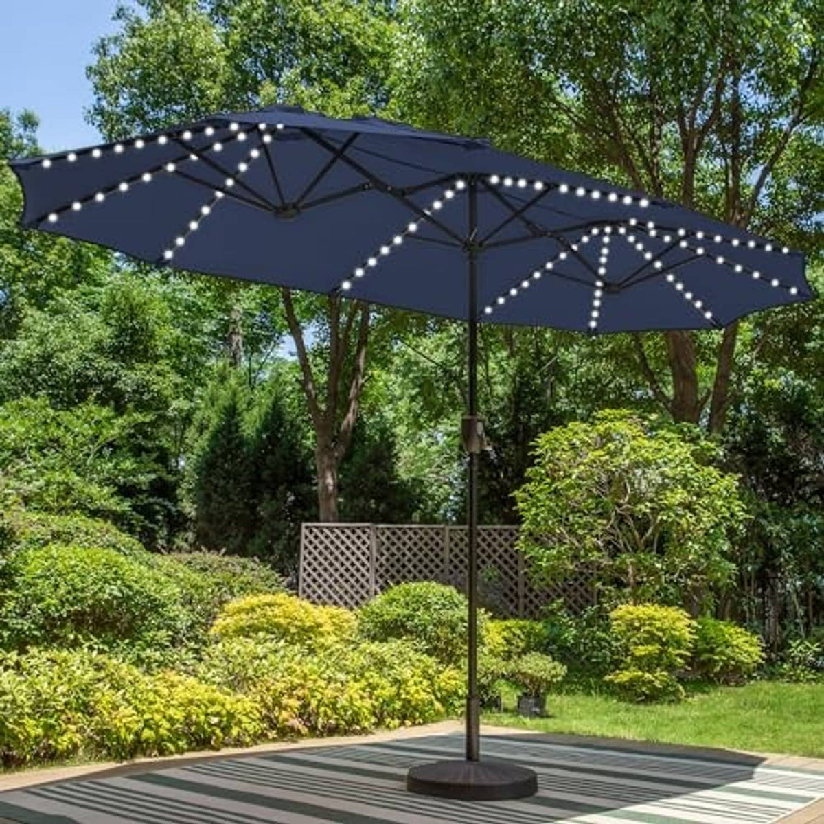 Navy patio umbrella with solar LED lights along canopy ribs and center spokes