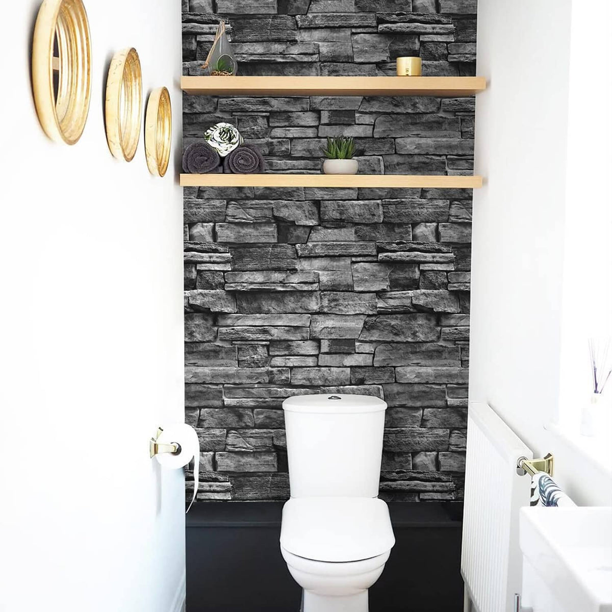 Dark gray brick-pattern wallpaper behind a white bathroom toilet and vanity.