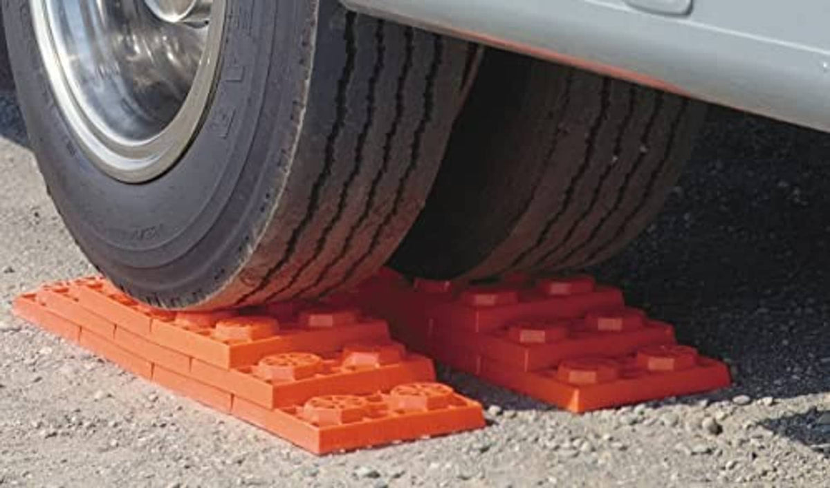Orange RV leveling blocks under tire tread for lift and leveling