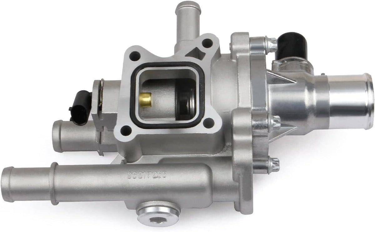 Thermostat housing assembly side view with square valve port and metallic fittings, silver.