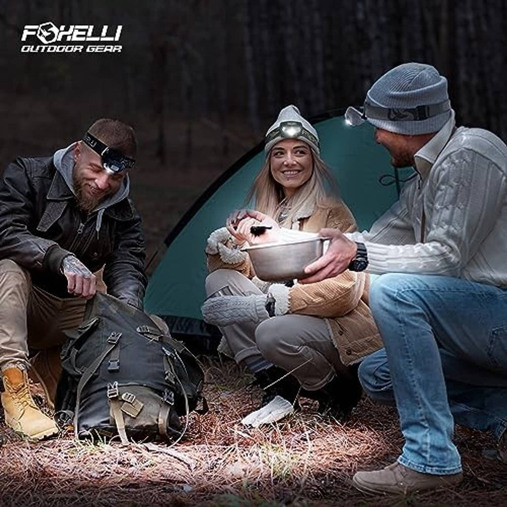 Foxelli rechargeable LED headlamp worn by campers in a tent setting at night