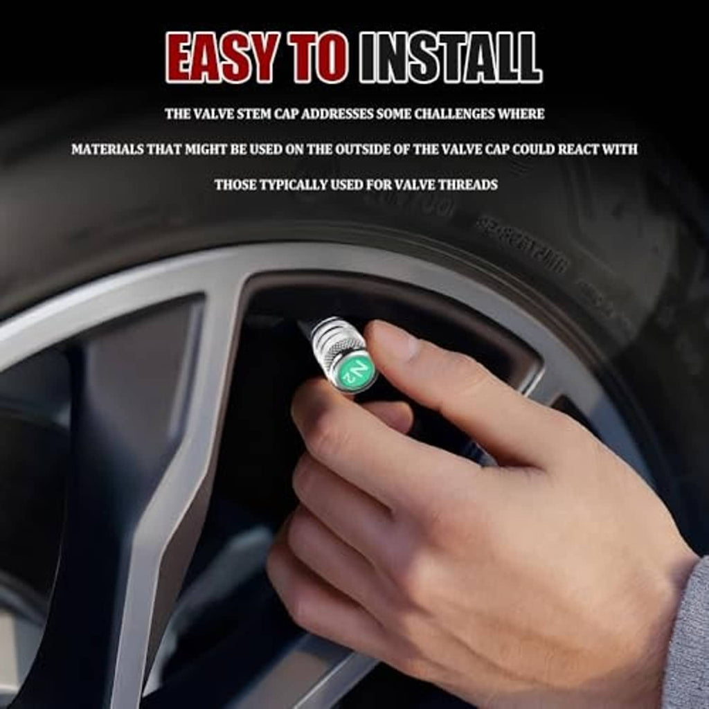 Silver tire valve stem cap with green N2 top being installed on a tire valve