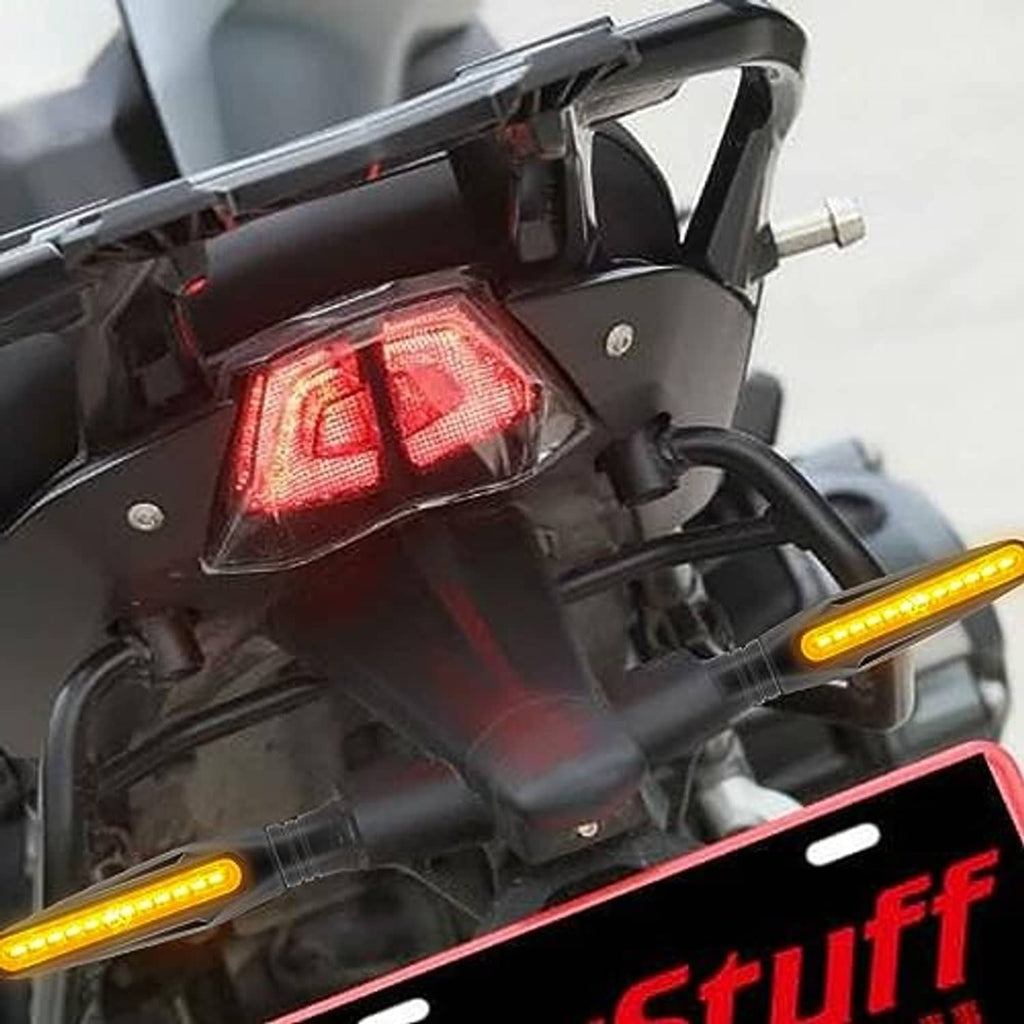 Close-up of motorcycle rear light area with amber LED turn signal bar and black housing