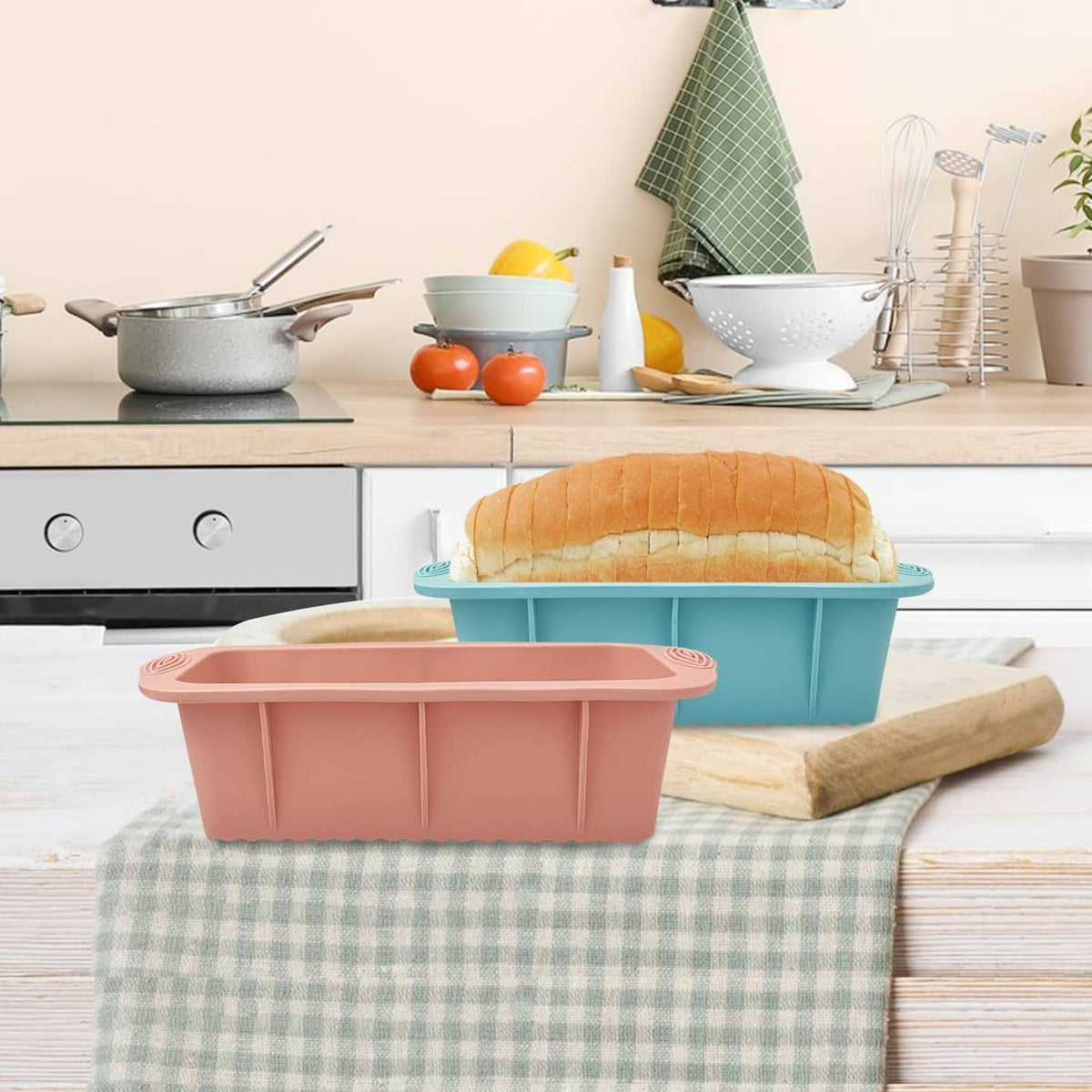 Pink and blue silicone rectangular bread loaf pans on a kitchen counter