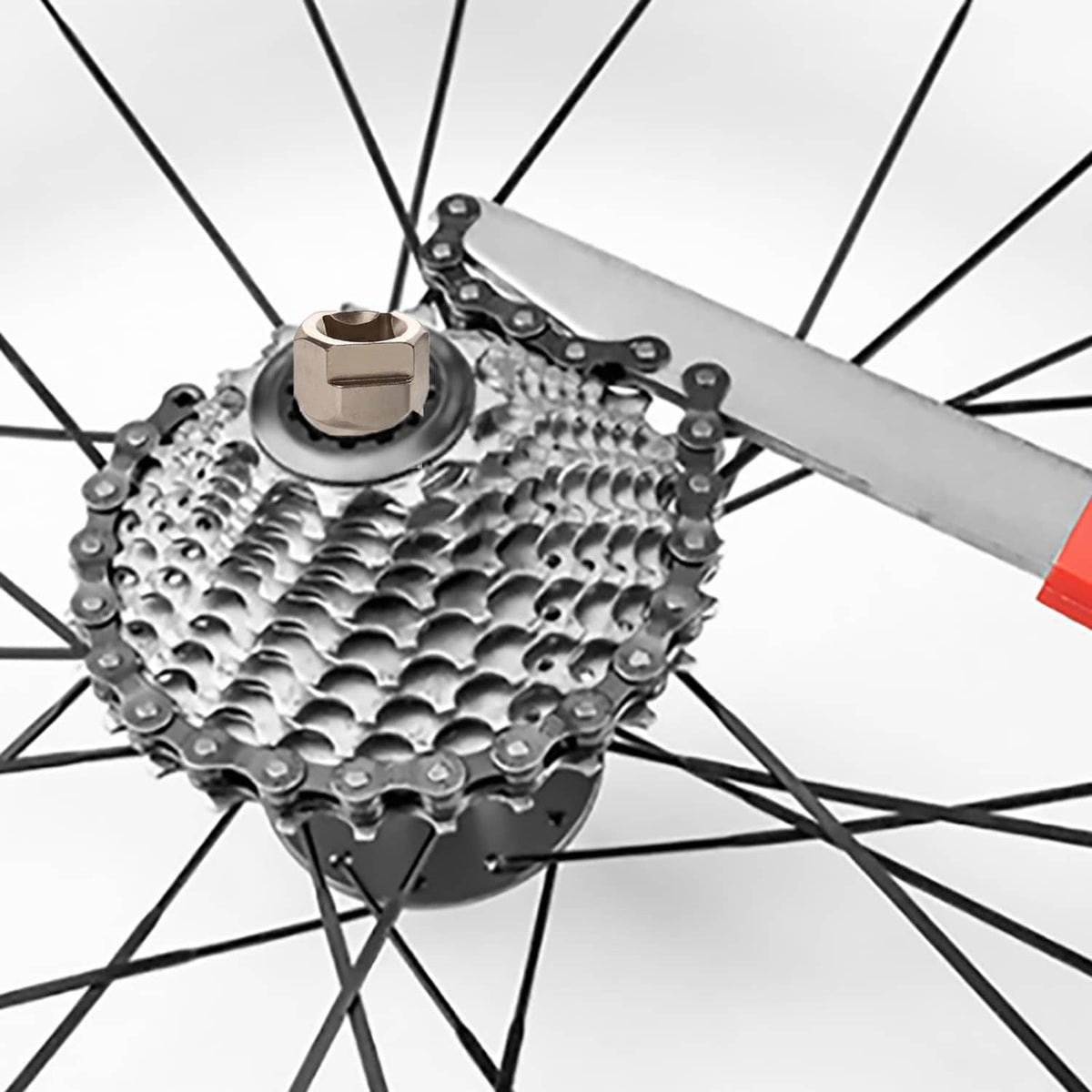 Bike freewheel removal tool with chain whip and silver socket on rear cassette