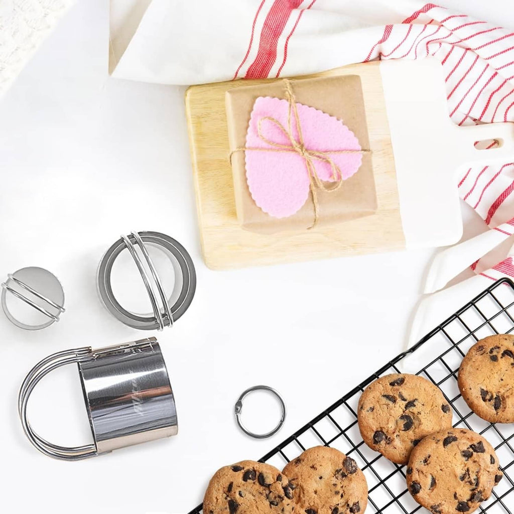 Stainless steel round biscuit cutters on a baking setup with cookies