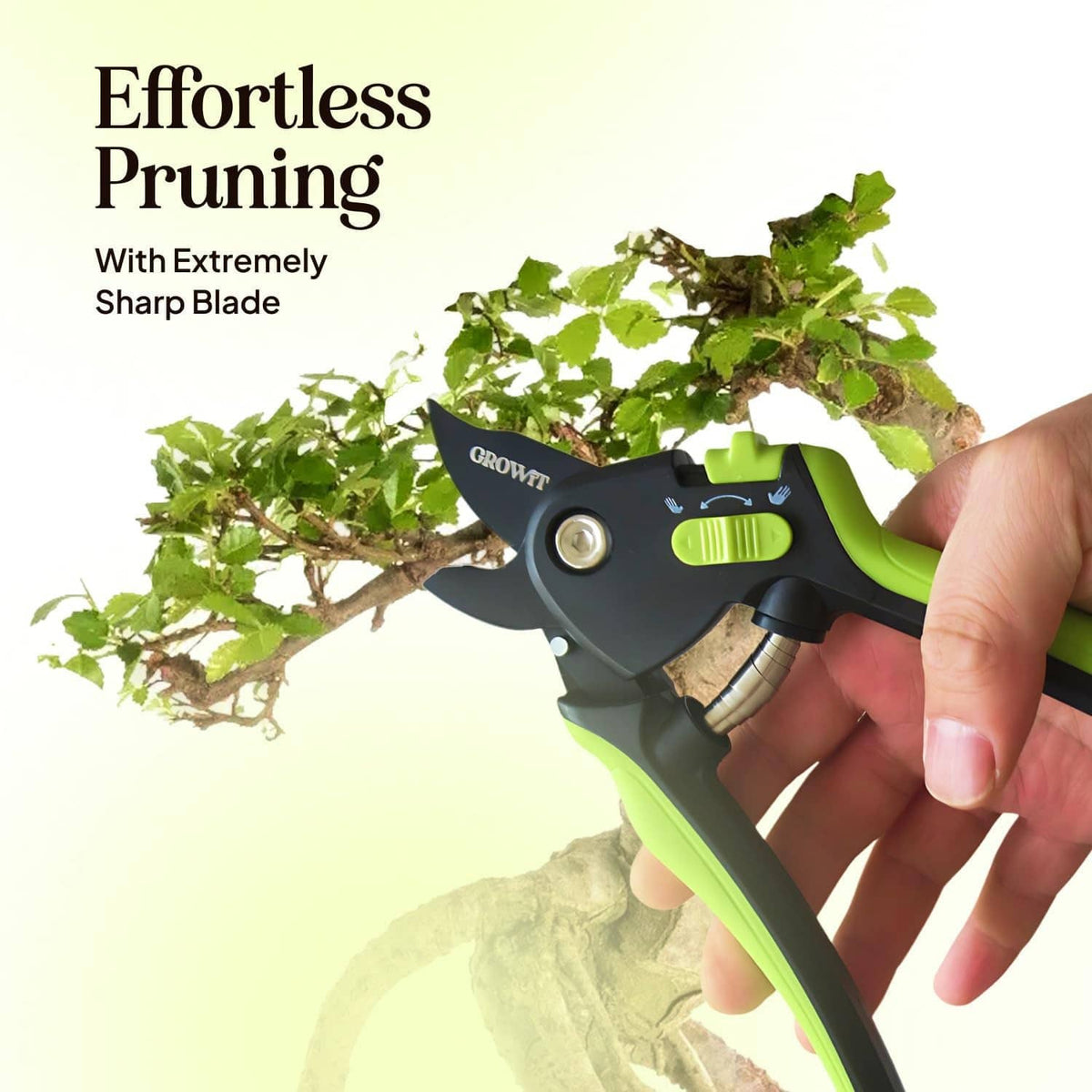 Hand holding black and neon green pruning shears with sharp curved blades