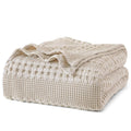 Ivory waffle-weave cotton blanket, king size, neatly folded with textured diamond pattern