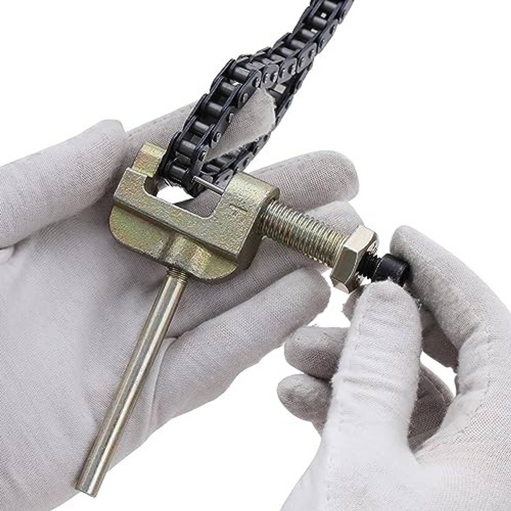 Link breaker tool holding a chain, with threaded screw and metal pin pusher