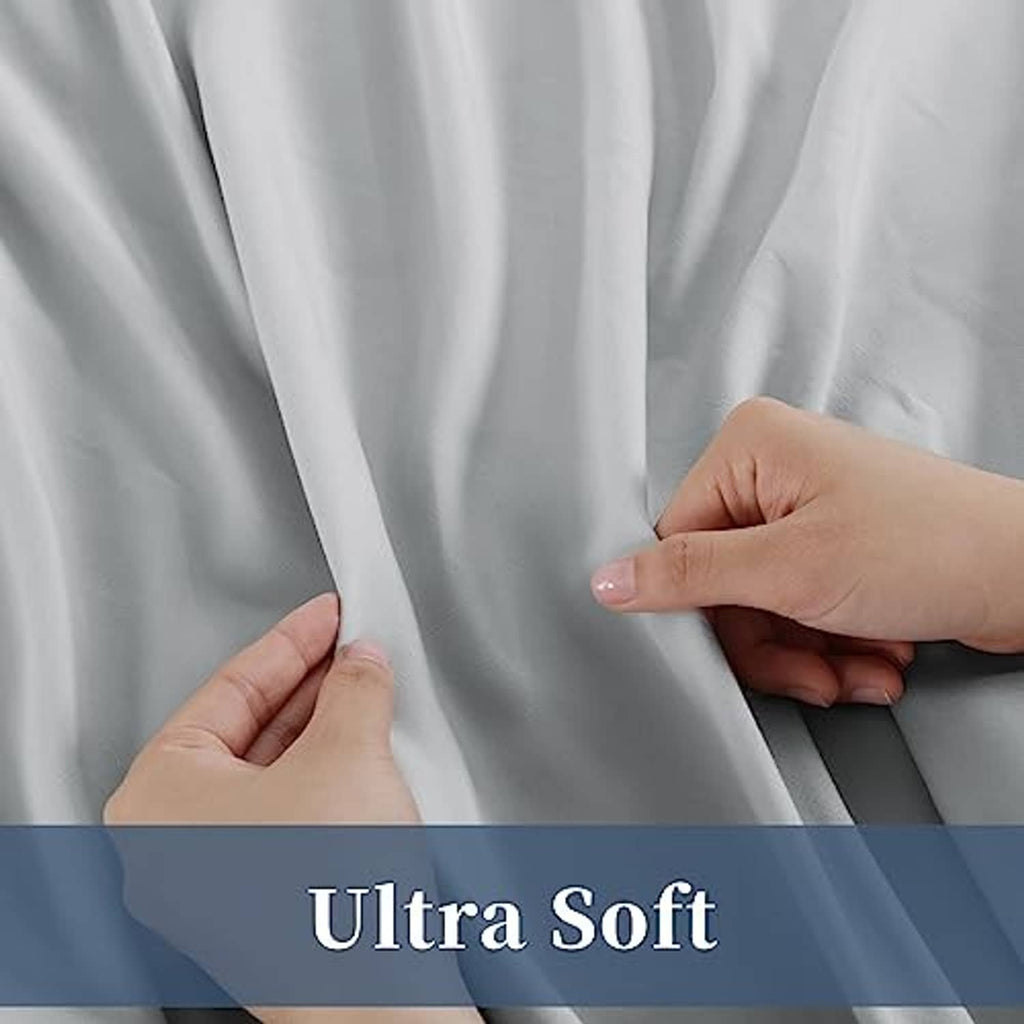 Light grey sheet fabric close-up, hands pinching smooth, soft material