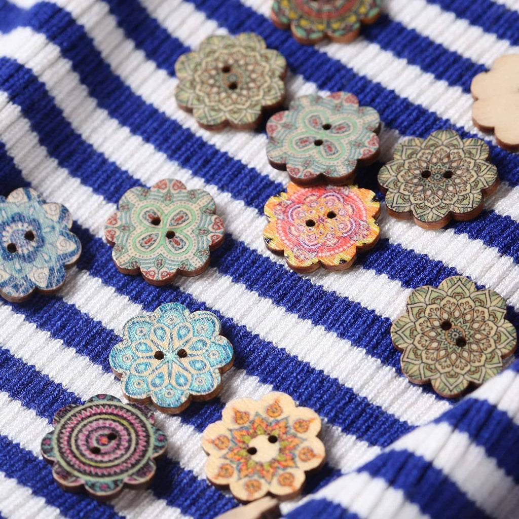 Wooden flower buttons with two holes on blue-and-white striped fabric