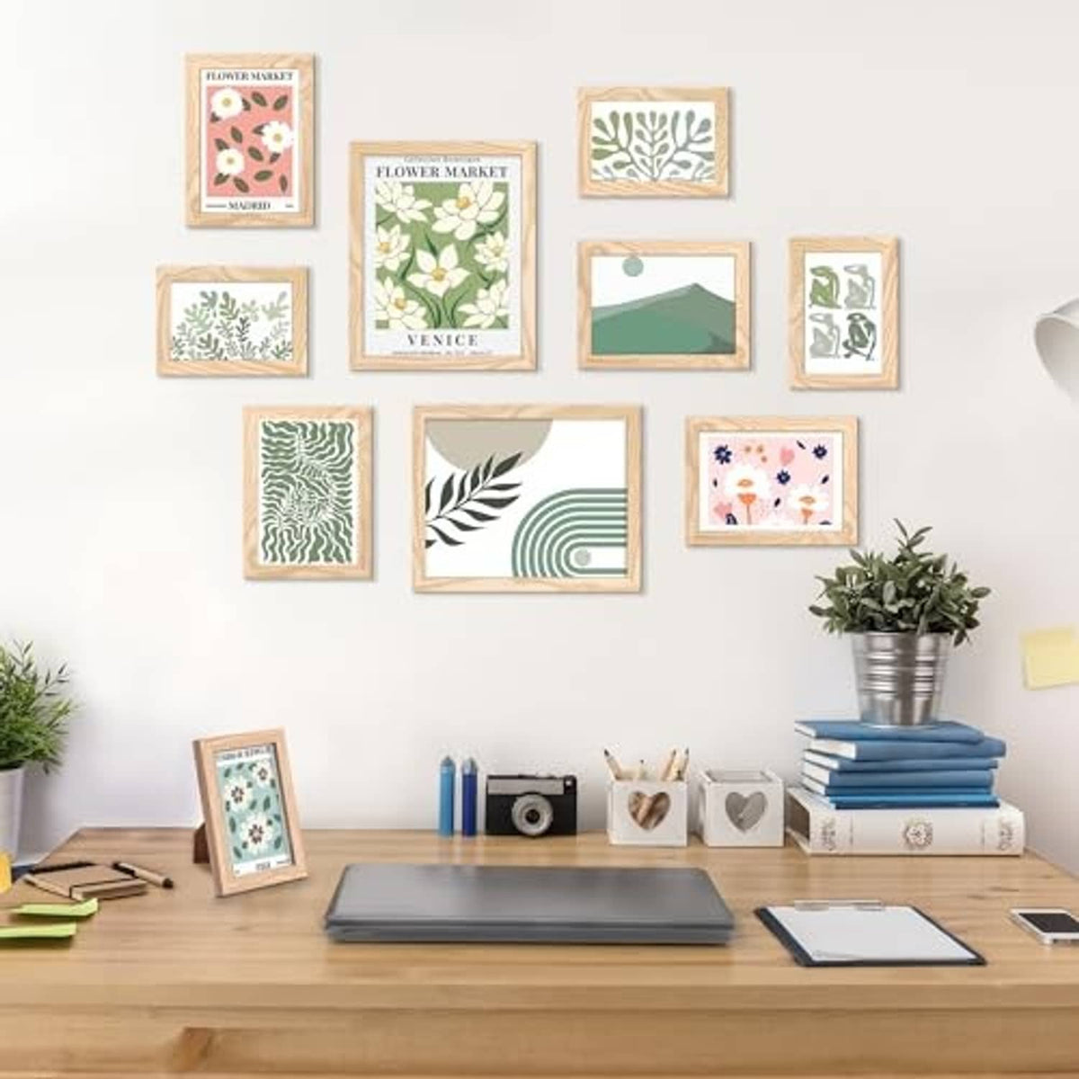 Natural wood picture frames set arranged on wall, assorted sizes with botanical prints