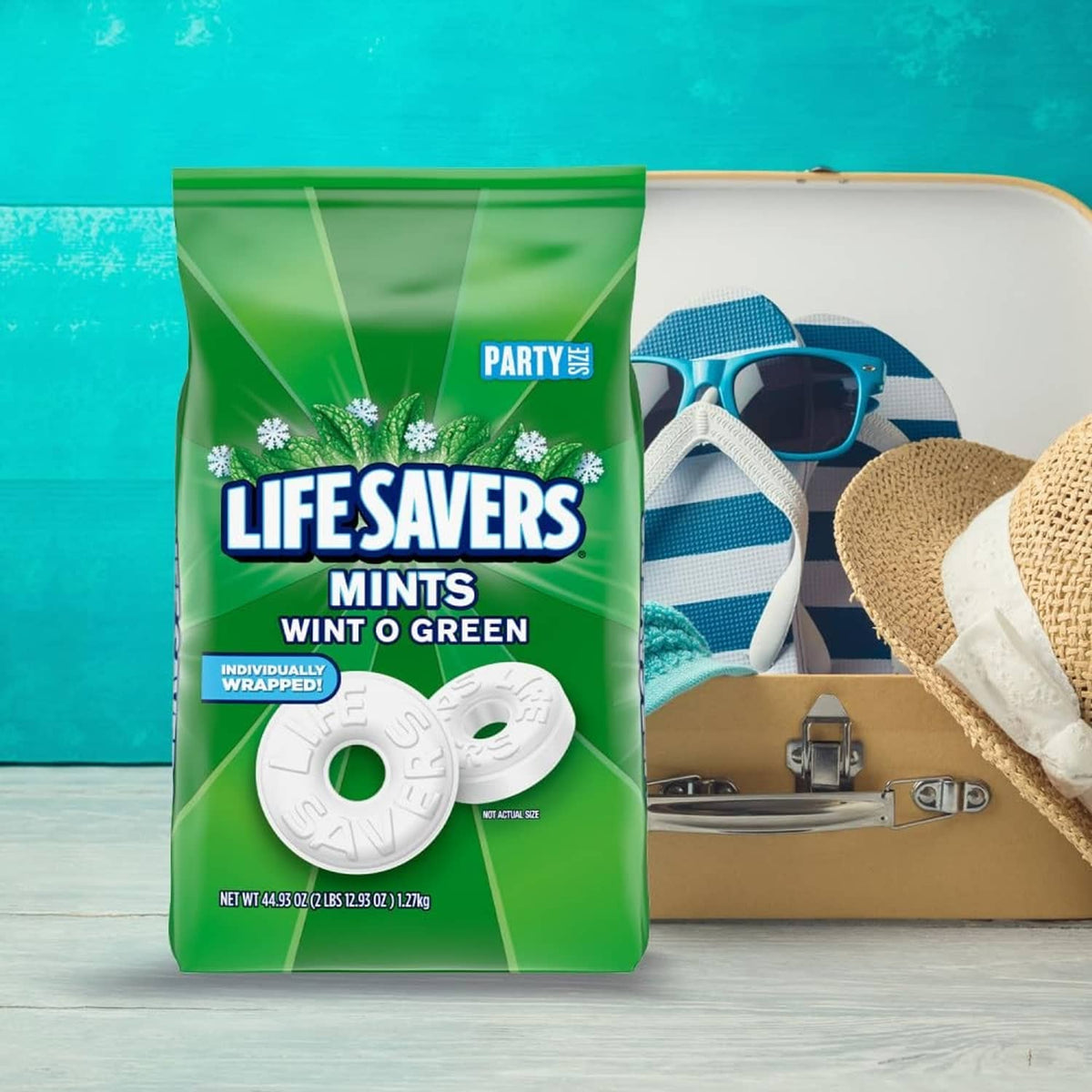 Green mints bag with white mint discs and party supplies in the package