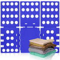 Blue T-shirt folding board with peg holes and folded shirts stacked beside it