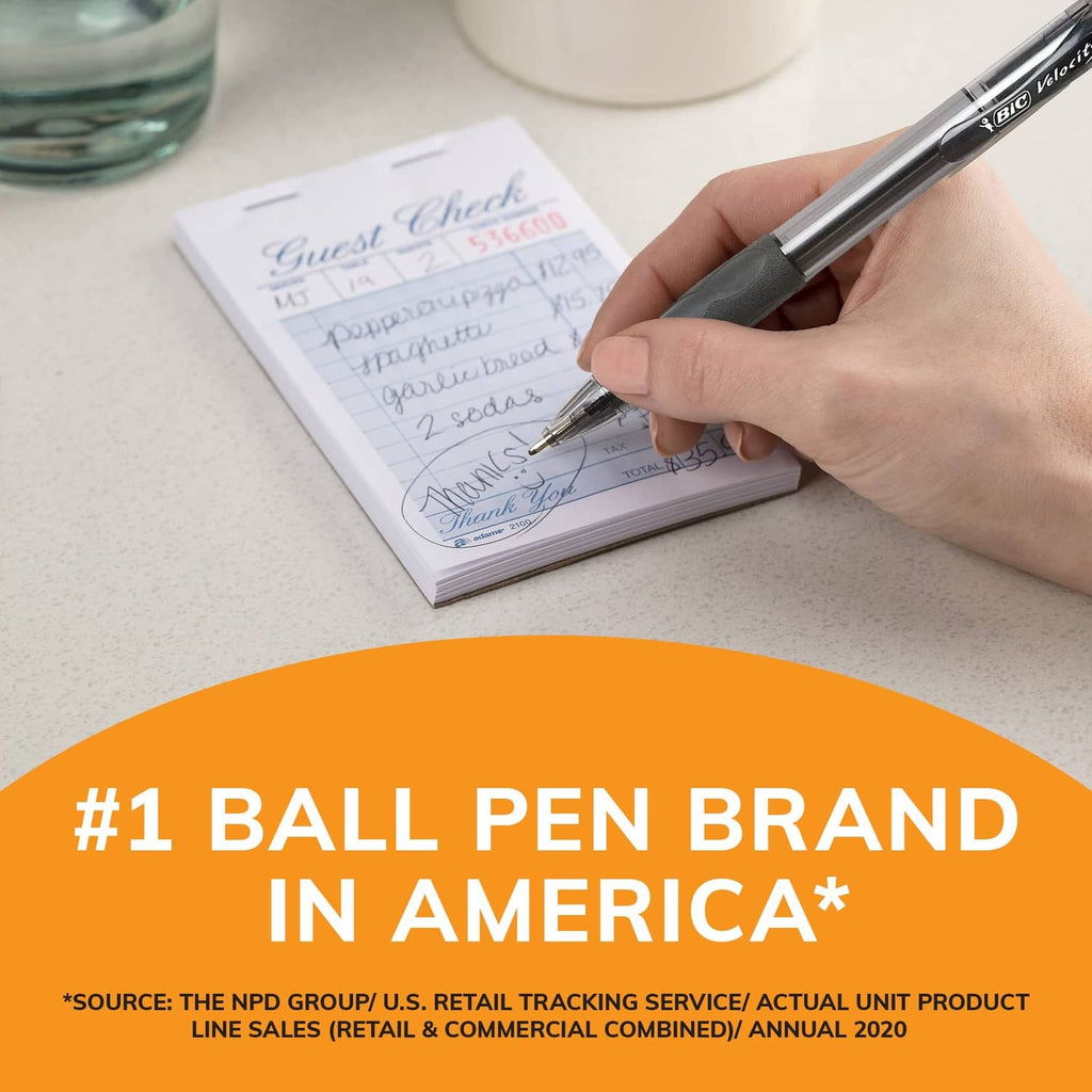 Hand writing with a retractable black ballpoint pen on lined paper, BIC.