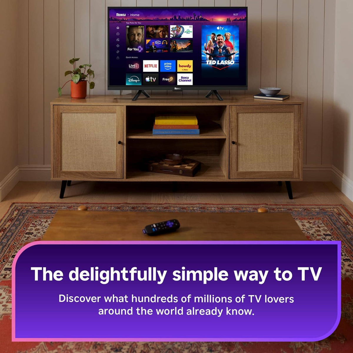 Roku streaming stick voice remote on living-room coffee table in front of TV