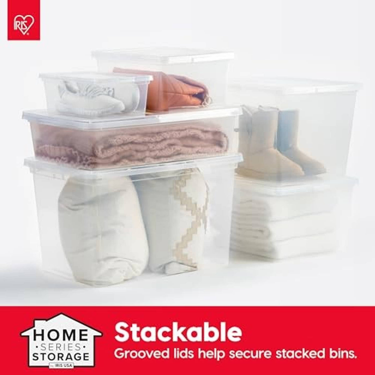 Stackable clear storage bins with grooved lids holding folded linens