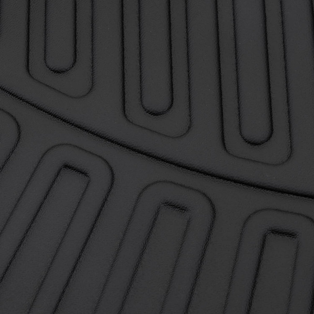 Black floor mat surface with raised channels and ridged texture