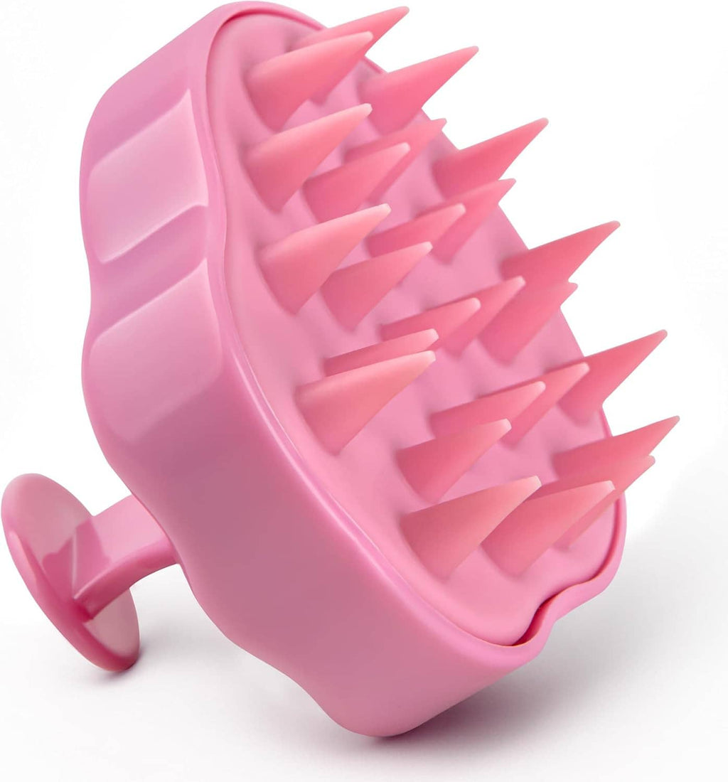 Pink scalp massager brush with soft triangular bristles
