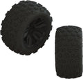 Two off-road glued tires with deep tread, black rubber; one tire shows a wheel rim
