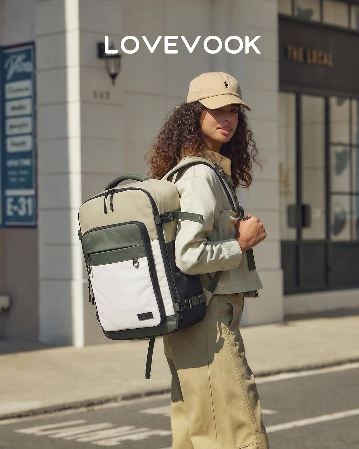 Olive and cream travel backpack worn on shoulder with front organizer pocket