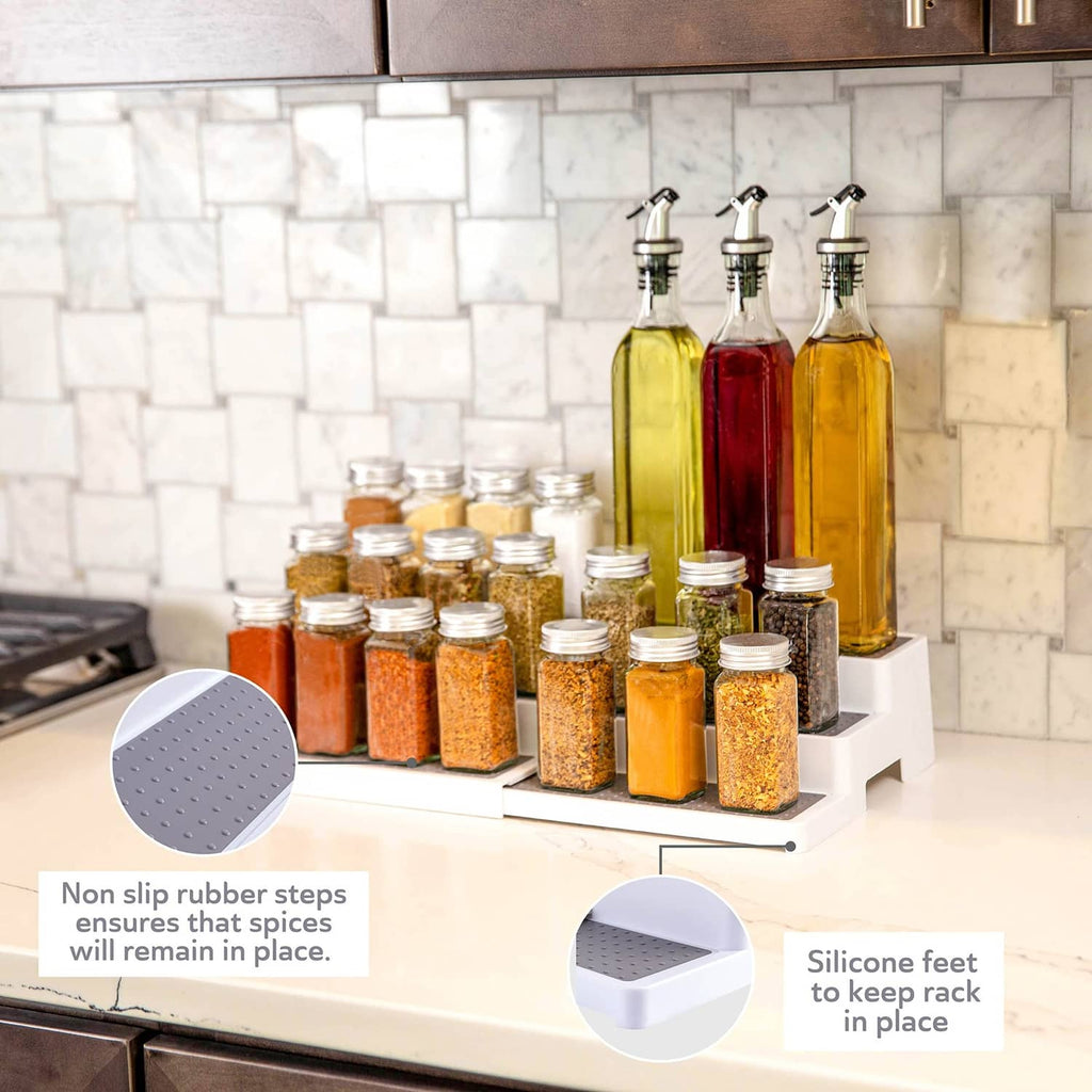 White 3-tier spice rack with gray perforated trays and jar/bottle storage on top.