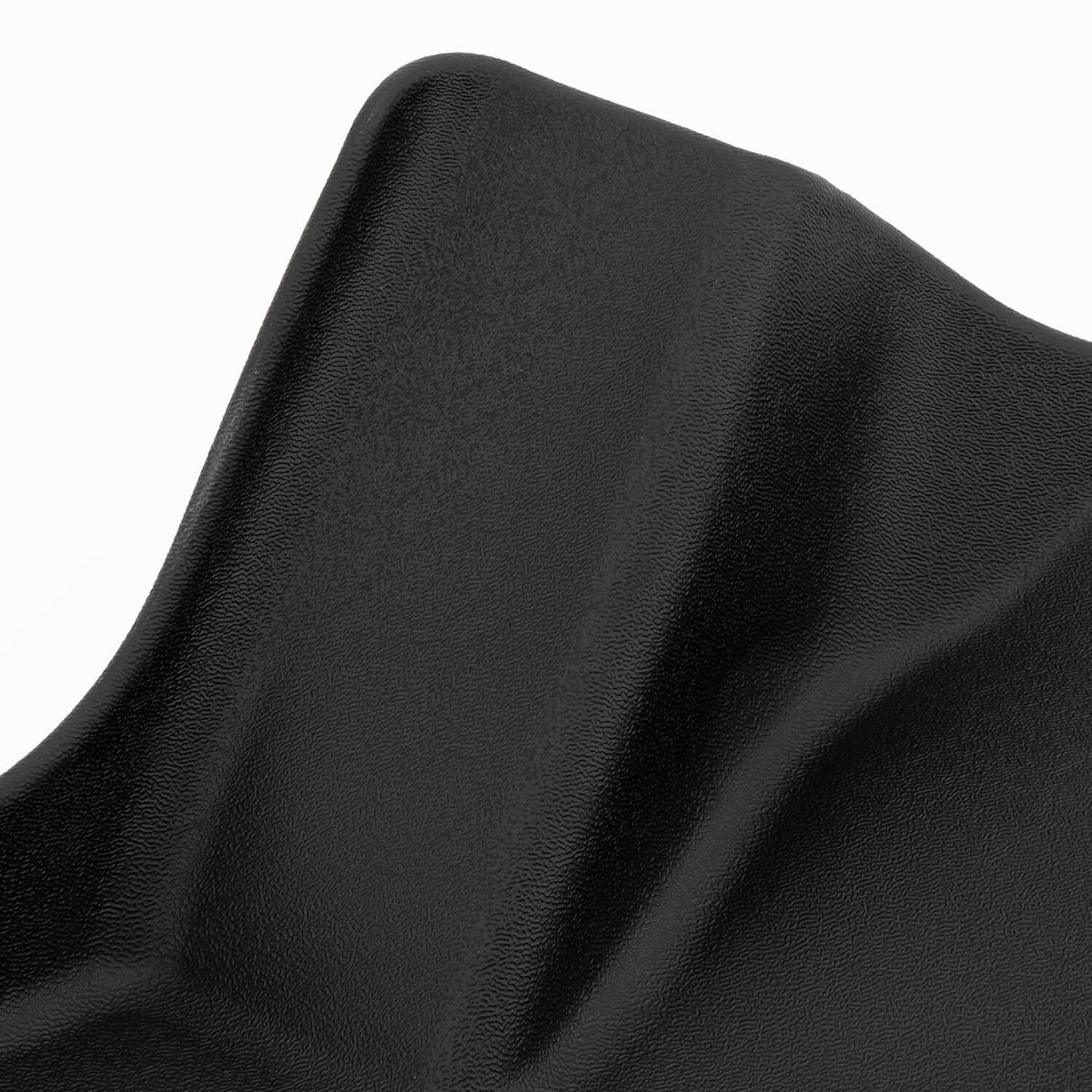 Black rubberized mat material with fine grain texture and curved edge.