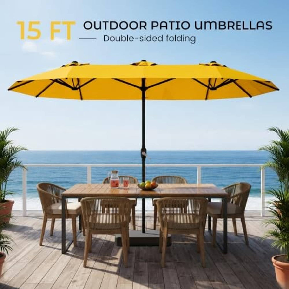 Golden yellow double-sided patio umbrella with black pole above outdoor dining table