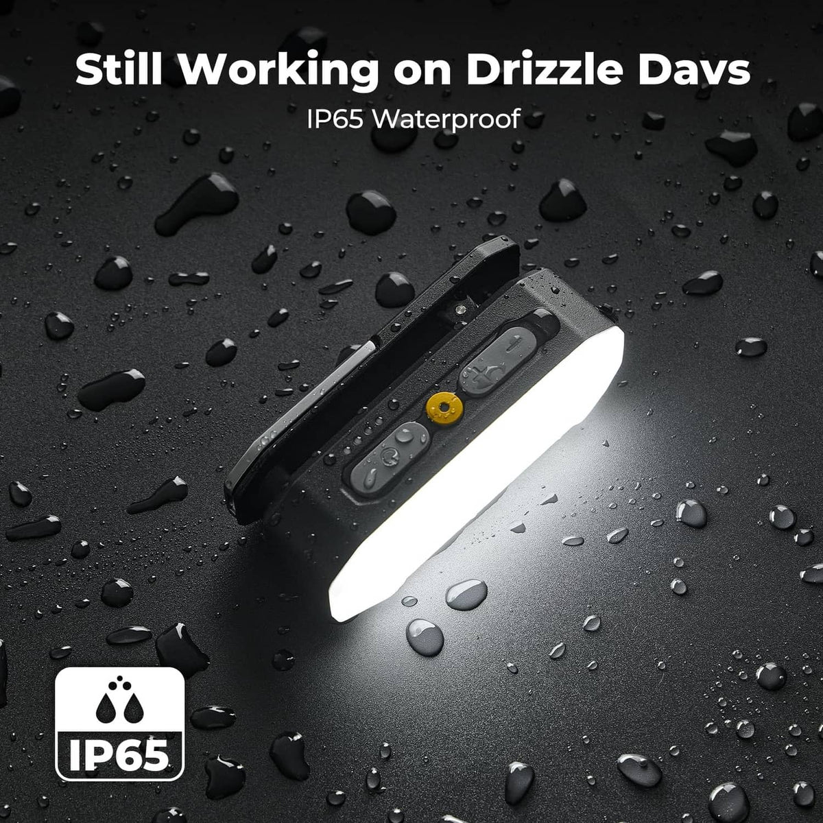 Black IP65 waterproof rechargeable light with raindrop-covered body