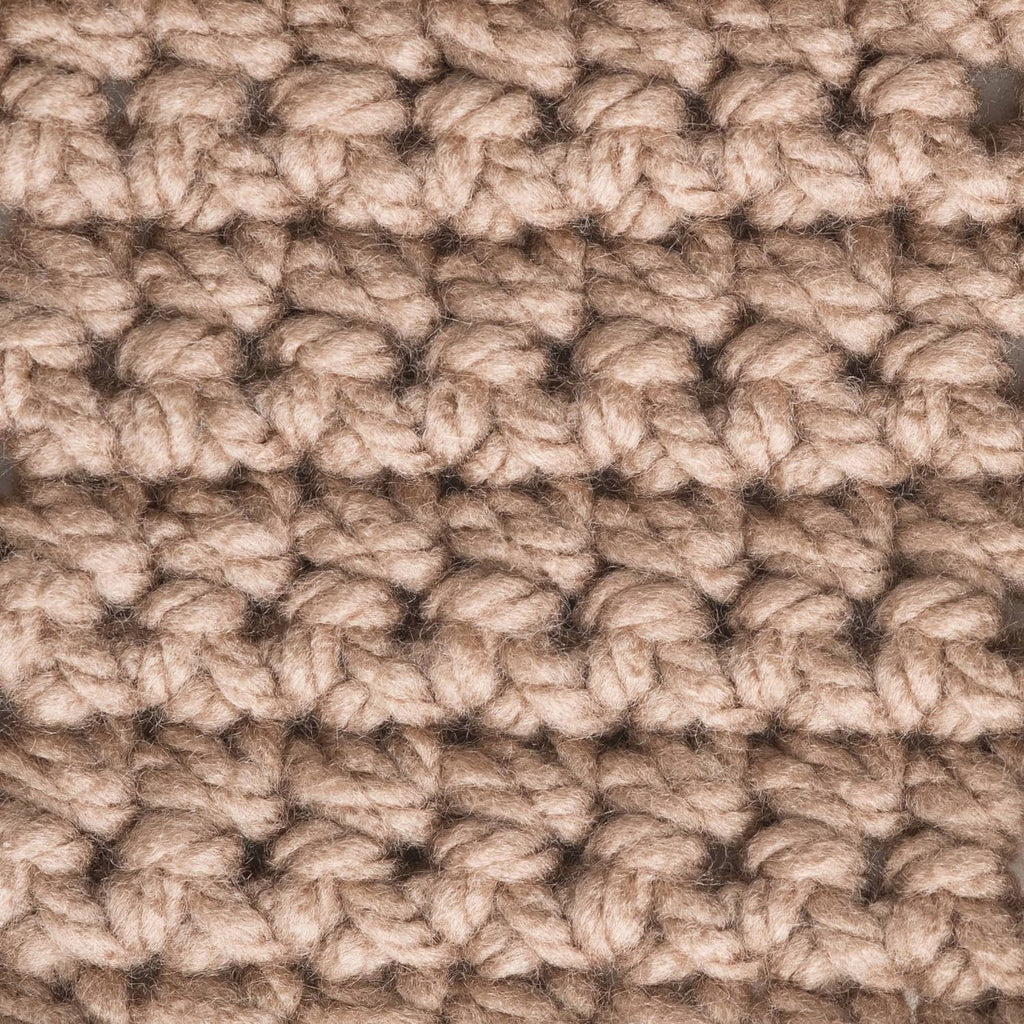 Taupe chunky yarn texture close-up with looped, nubby stitches