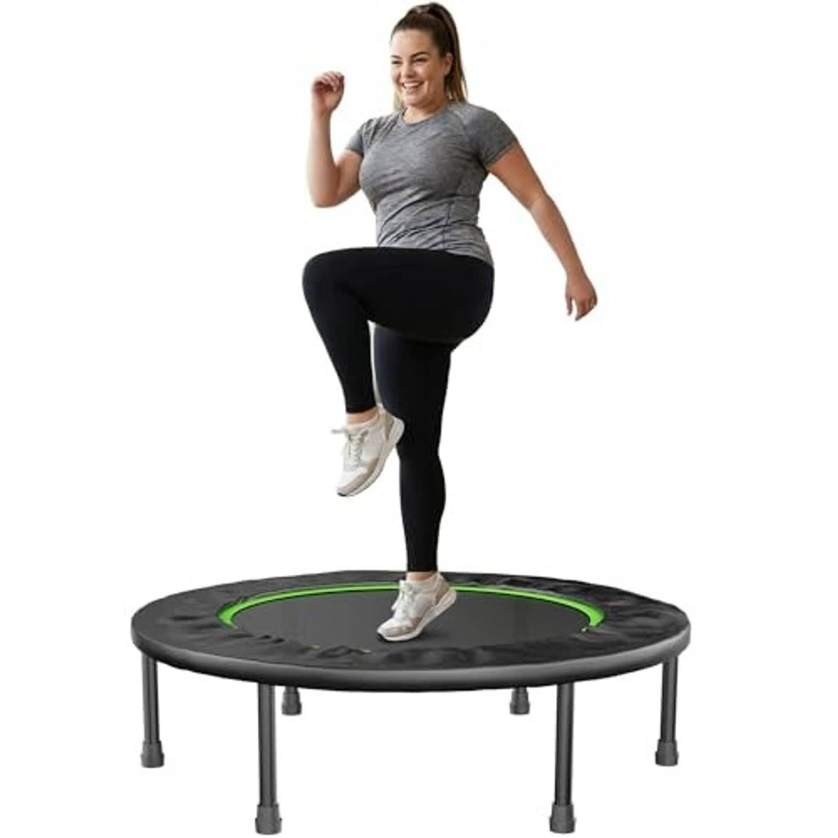Mini trampoline with dark round mat and green rebound band, person stepping