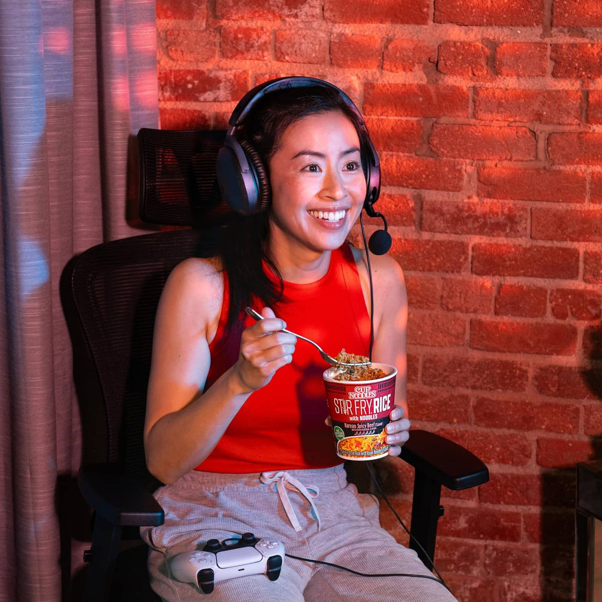 Nissin Cup Noodles Stir Fry Rice cup held by person with spoon and fork