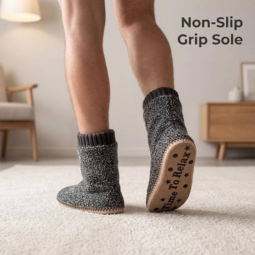 Grey fuzzy boot slipper on foot with ribbed cuff and tan outsole