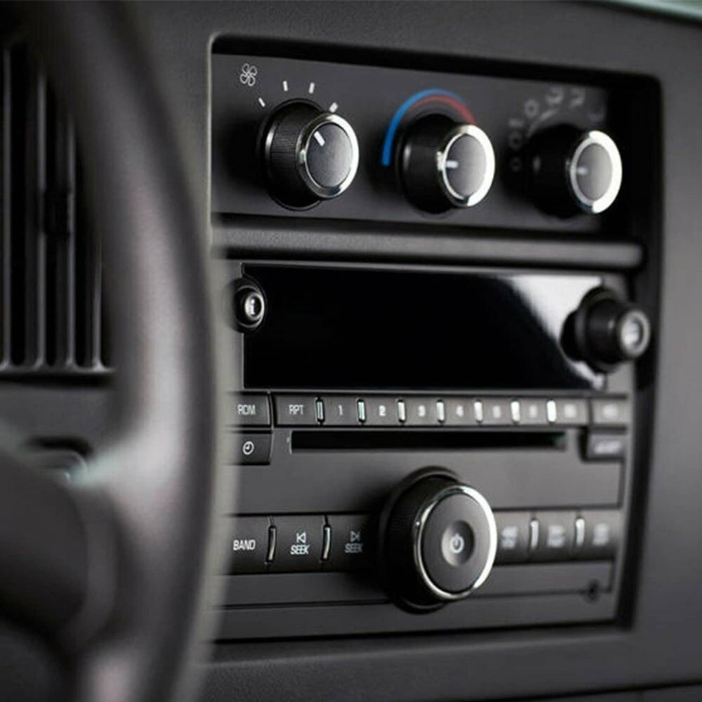 HVAC control panel with three black temperature knobs and textured silver-edged buttons