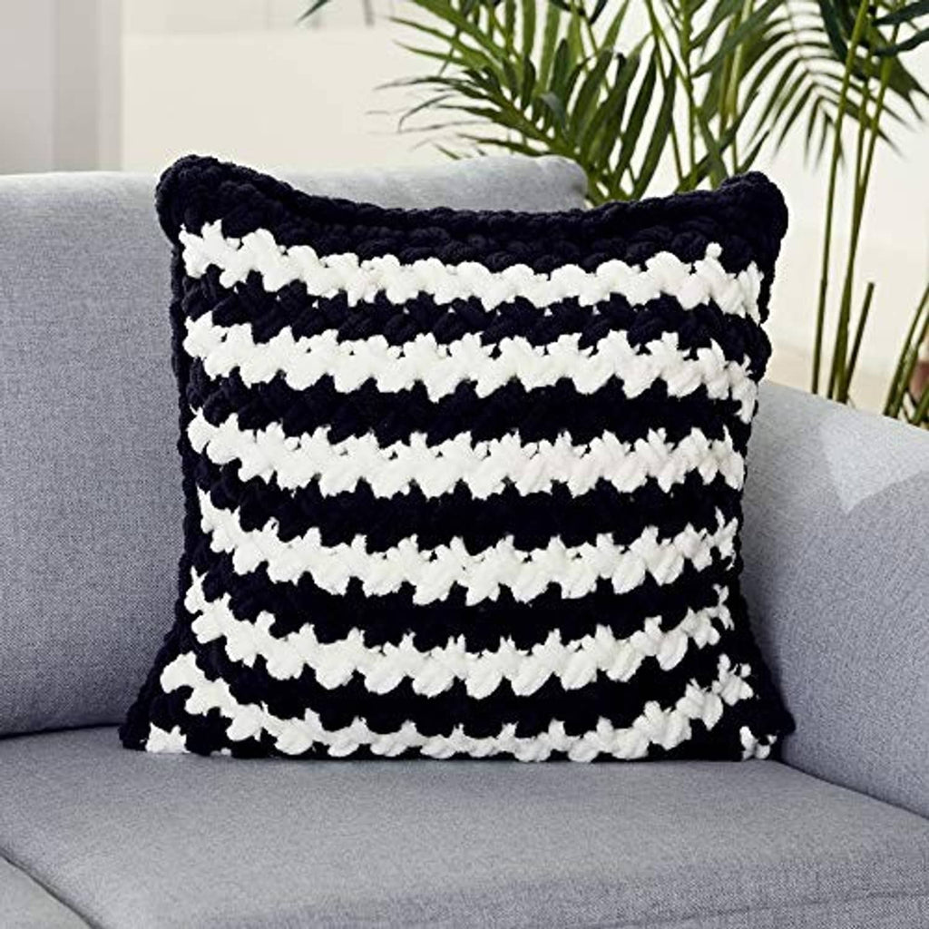 Handmade finger-loop knit pillow cover with black and white stripe pattern